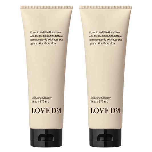 Two beige tubes of Loved 01 Deep Moisturizing Exfoliating Cleanser (6oz each), a 2-pack infused with nourishing Rosehip Oil and Sea Buckthorn Oil, both featuring black caps.