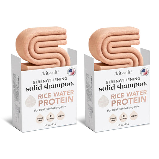 Two boxes of Kitsch All Natural Rice Water Strengthening Shampoo Bar 3.2oz (2 Pack) by Kitsch, featuring pink, S-shaped solid bars partially out of the packaging for healthy hair growth.