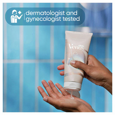 A hand dispenses Gillette Venus Intimate Grooming Skin-Smoothing Exfoliant onto the palm, with a label stating dermatologist and gynecologist tested—designed as a pre-shave exfoliant to help prevent ingrown hairs.