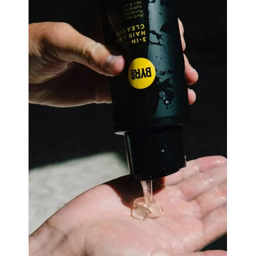 A person squeezes clear gel from a BYRD 3 Pack 3-in-1 Hair & Body Cleanser Coconut & Sea Salt 15oz bottle into their open palm.