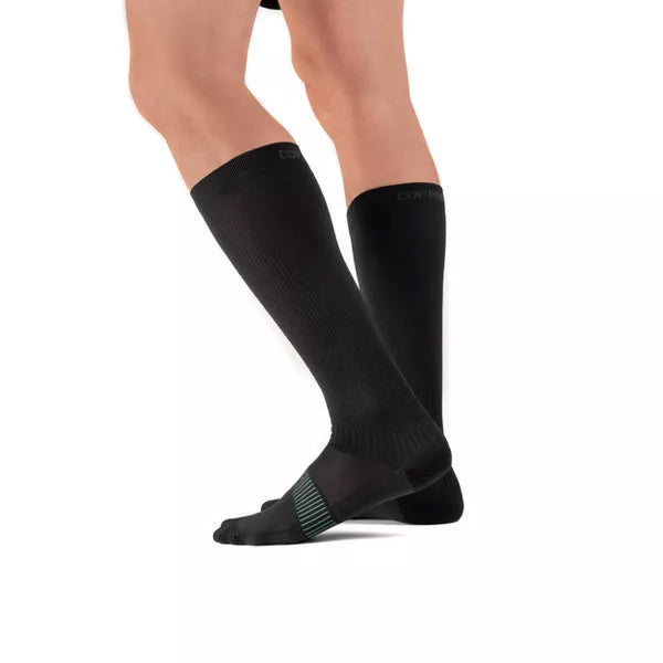 A person wears Copper Fit Ice Menthol Infused Compression Socks (S/M, 2 Pack), shown knee-down on a white background.