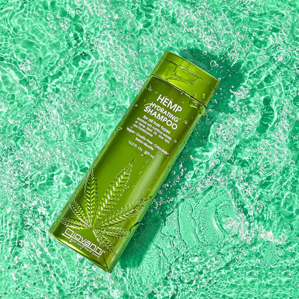 A 2 pack of Giovanni Natural Hemp Seed Oil Shampoo with Aloe Vera, each 8.5oz bottle, floats on clear, rippling water.