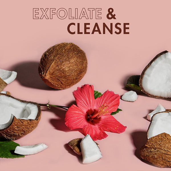 A hibiscus flower is surrounded by coconut pieces on a pink surface, with the text SheaMoisture 2 Pack - Body Scrub for Dull Skin Coconut & Hibiscus 12oz above.