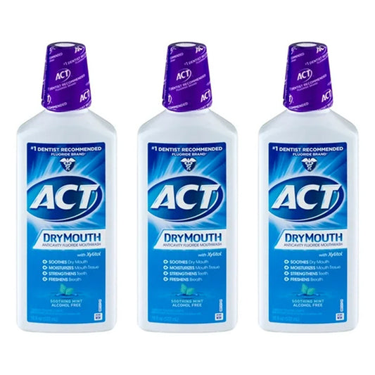 Three bottles of ACT Dry Mouth Fluoride Mouthwash, Soothing Mint flavor (18oz each), are arranged side by side. This product comes in a 3 pack and is alcohol free.