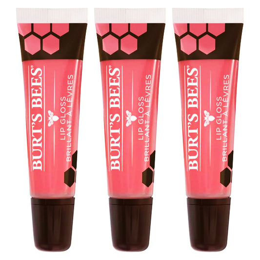 Three upright Burts Bees 100% Natural Moisturizing Lip Glosses, Punch of Pink (3 Pack, 0.5oz each), with black caps and bee-themed packaging. Each gloss is enriched with Avocado Oil for a smooth, moisturizing finish.