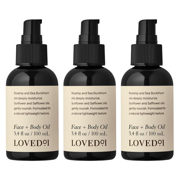 The Loved 01 3 Pack Face + Body Oil with Rosehip & Sea Buckthorn (3.4oz each) hydrates and nourishes skin, featuring beige labels with ingredients and details.