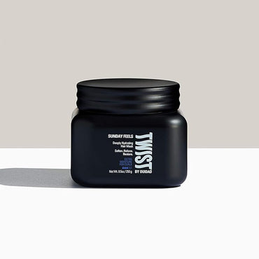 A black jar labeled TWIST, from the 3 Pack - TWIST Sunday Feels Deeply Hydrating Hair Mask 8.5 oz set, sits on a white surface against a two-tone beige and light gray background.