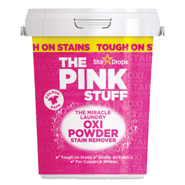 A white tub labeled Star Drops The Pink Stuff Miracle Laundry Oxi Powder Stain Remover for Colors (3 Pack, 2.2lbs) features bold pink and yellow branding, showcasing powerful stain removal for colored laundry.