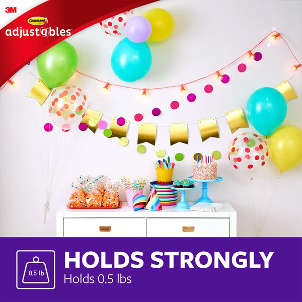 A festive party setup with balloons, banners, and treats on a white table showcases 3M’s 3 Pack - 17840CLR-14ES Adjustables Clips & Strips (14 repositionable clips/30 strips each); text reads Holds Strongly and Holds 0.5 lbs for damage-free hanging.