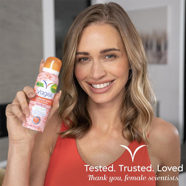 A woman with shoulder-length hair smiles while holding a can of Vagisil Scentsitive Scents Feminine Dry Wash Deodorant Spray 2.6oz (3 Pack). Text on the image reads, Tested. Trusted. Loved. Thank you, female scientists, for caring for intimate skin.