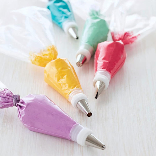 Four packs of Wilton Disposable 16 Decorating Bags (12 count each) are displayed, each filled with colorful icing and fitted with metal decorating tips.