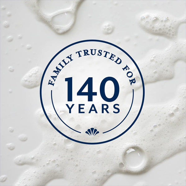 Circular badge with Family Trusted for 140 Years over white soap bubbles, highlighting dermatologist tested Ivory Mild & Gentle Body Wash Original Scent 35oz, 4 Pack—made with plant-based cleansers by Ivory.