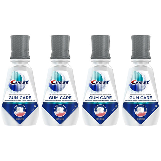 Four bottles of Crest Gum Care Mouthwash Cool Wintergreen with CPC, 16.9oz each, are arranged side by side on a white background, helping you fight plaque germs effectively.