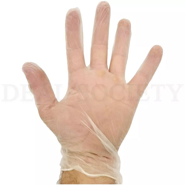 A hand wears a clear, powder-free Unbranded vinyl glove (X-Large) from the 6 Pack – 100 ct each set, shown upright with fingers spread against a plain background.