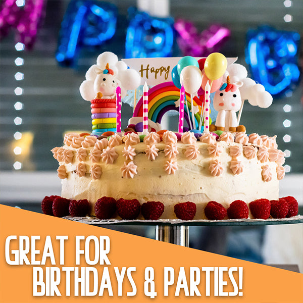 A decorated birthday cake with unicorn and rainbow toppers, raspberries, and a Deal Society 100 Piece Mexican Candy Variety Bulk Pack, with “GREAT FOR BIRTHDAYS & PARTIES!” at the bottom.