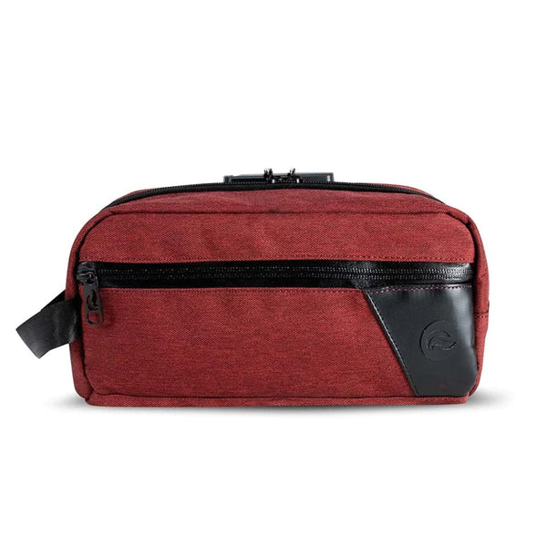 The Skunk DOPE Kit is a rectangular maroon, carbon-lined, odor-proof storage bag with a black front zipper pocket, black corner accent, and small side strap, crafted from water-resistant material and displayed on a white background.