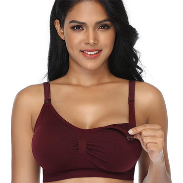 A woman models the GXXGE 4 Pack Medium Push Up Seamless Nursing Bra, lifting one cup to show its padded, wire-free breastfeeding access, against a plain background.