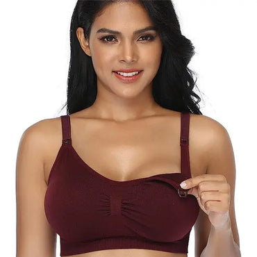 A woman models the GXXGE 4 Pack Medium Push Up Seamless Nursing Bra, lifting one cup to show its padded, wire-free breastfeeding access, against a plain background.