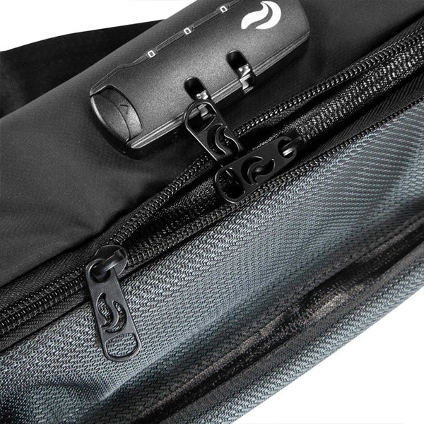 Close-up of the Skunk Drifter Medium Crossbody Bag in Metal Gray, featuring dual zippers, a combo lock on the top compartment, and 100% smell- and weather-proof carbon lining for secure odor-free storage.