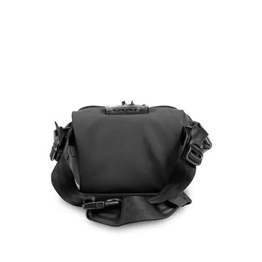 The Skunk Drifter Small Crossbody Bag in Metal Gray features 100% smell and weather proof carbon lining, a wide adjustable strap, buckles, and a top lock, designed with SK9® Smell Proof Tech, shown against a white background.