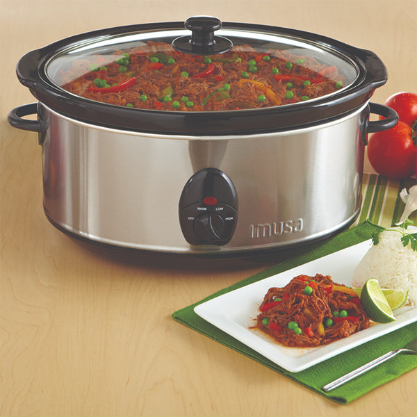The IMUSA Electric Stainless Steel PTFE Nonstick Slow Cooker 3.7 Quarts is filled with shredded beef stew, served with rice, lime, and tomatoes on a wooden table for a delicious one-pot meal.
