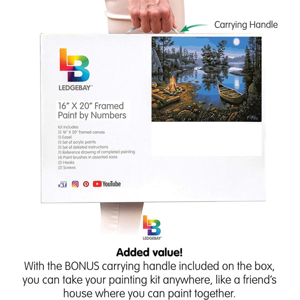 A hand holds a Ledgebay Paint by Number for Adults Framed Canvas Moonlight Bay, 16 x 20, showcasing the framed kit box with landscape art and details perfect for DIY adult arts and crafts.