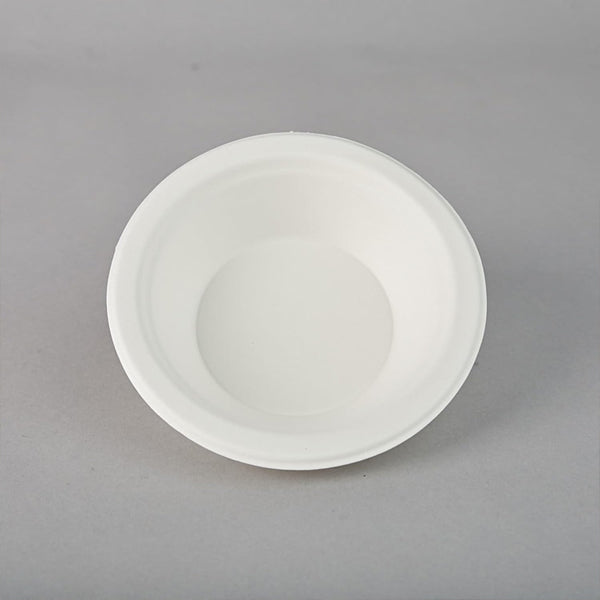 A plain, white, round Emerald Ecovations Tree-Free Compostable 16oz Bowl is shown on a gray background—eco-friendly and perfect for sustainable dining; available in a 125 count pack.