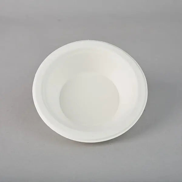 A plain, white, round Emerald Ecovations Tree-Free Compostable 16oz Bowl is shown on a gray background—eco-friendly and perfect for sustainable dining; available in a 125 count pack.
