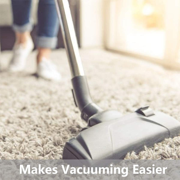 A person vacuums a carpet using the Unbranded 2 Pack - 3x5 Non Slip Area Rug Pad Gripper for Area Rugs and Hardwood Floors. Text reads: Extra cushioning from this non-slip rug pad makes vacuuming easier.