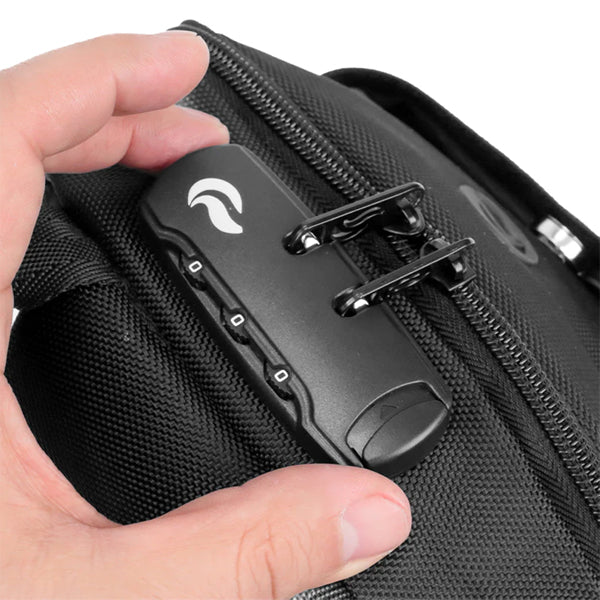 A hand adjusts a three-digit combination lock on the Skunk Uno Crossbody Sling Bag, a black, 100% smell-proof, weather-proof bag with carbon lining and two zipper pulls secured in the lock.