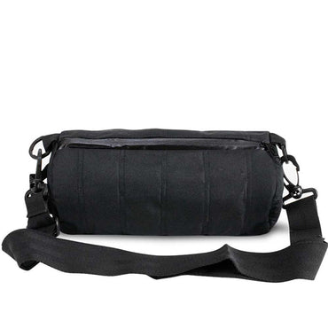 The Skunk Uptown Crossbody Duffle Bag, shown in black with a cylindrical shape, zippered top, adjustable strap, and 100% smell & weather proof carbon lining, is displayed against a white background.