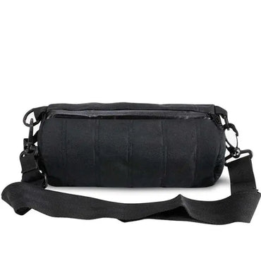 The Skunk Uptown Crossbody Duffle Bag, shown in black with a cylindrical shape, zippered top, adjustable strap, and 100% smell & weather proof carbon lining, is displayed against a white background.