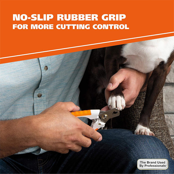 A person trims a dogs nails using the WAHL Stainless Steel Pet Nail Clipper (Model 858448), featuring orange handles and a no-slip rubber grip for better control.