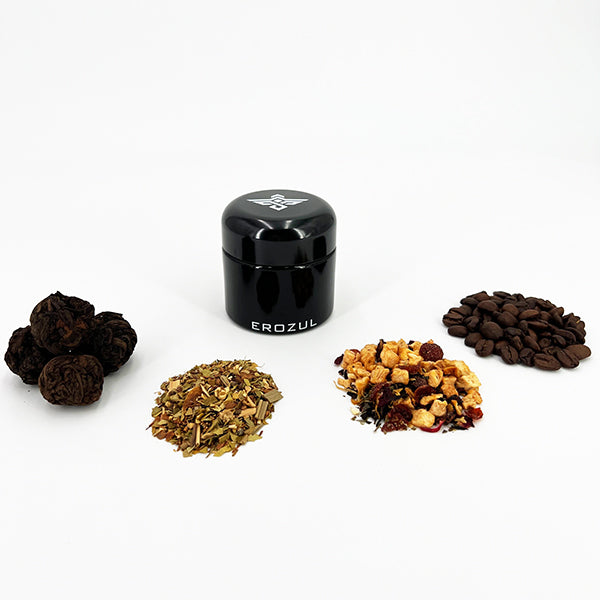 An Erozul 60ml Screw Top Wide Mouth Glass UV Jar from Erozul (3 Pack) sits centered among four piles—dried black balls, loose herbs, mixed dried fruits, and coffee beans—all on a white background.