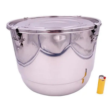 The CVault 21 Liter Humidity Control Airtight Metal Stash Smell Proof Container by CVault, shown next to a yellow lighter for scale, features a sealed lid with metal clasps and a reflective stainless steel surface for optimal storage.
