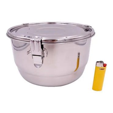 The CVault 4 Liter Humidity Control Airtight Metal Stash Container by CVault is shown beside a yellow lighter for size comparison.