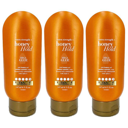 Three bottles of OGX Extra Strength Honey Hold Mega Glue, 5 ounces each, stand upright on a white background—ideal for all-day, unbeatable hold. Available in 3 or 6 packs.