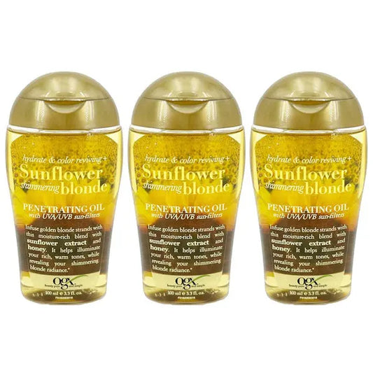 Three bottles of OGX Hydrate Color Reviving Sunflower Shimmering Blonde Penetrating Oil, featuring gold caps and yellow oil, to hydrate and enhance blonde hair with sunflower extract and UV filters.