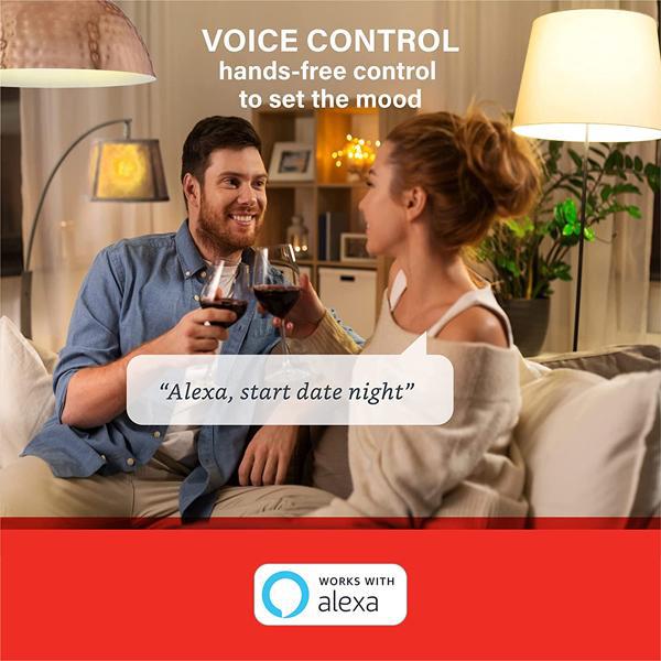 A couple clinks wine glasses on a couch as text promotes Alexa voice control with Sengled Smart Bulb Dimmable LED Bulb E26, 60W Equivalent Soft White 800LM - 3 Pack for setting the mood. The prompt reads, “Alexa, start date night.”.