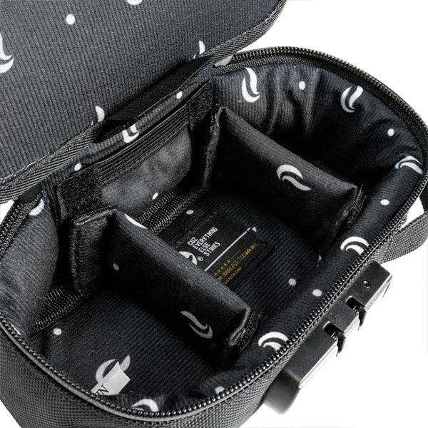 Open black Skunk SideKick Smell Proof Bag with combo lock features a soft padded interior, divider sections, dot and swoosh patterned lining, zipper closure, visible interior label, and premium carbon lining for extra protection.