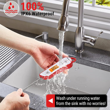 A person rinses the ThermoPro TP15 Waterproof Instant Read Food Thermometer under running water in a kitchen sink, demonstrating its waterproof design.